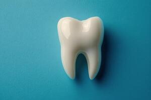 A detailed view of a healthy human tooth on a blue background showcasing dental anatomy clearly photo