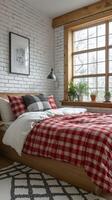 Cozy bedroom with a rustic charm featuring a plaid blanket and large window photo