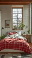 Cozy bedroom with a rustic charm featuring a plaid blanket and large window photo
