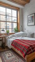 Cozy bedroom with a rustic charm featuring a plaid blanket and large window photo
