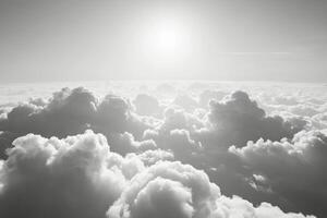 Sunrise over a sea of clouds showcasing dramatic light and shadow in black and white photo