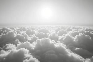Sunrise over a sea of clouds showcasing dramatic light and shadow in black and white photo