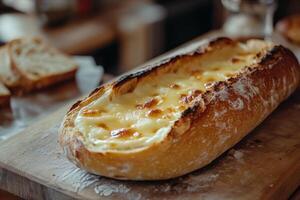 Freshly baked bread loaf with melted butter served on a wooden cutting board in a cozy kitchen photo