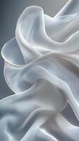 Soft white fabric texture with elegant folds and gentle draping in natural light photo