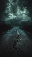 Dark and moody cracked road under stormy sky at dusk with ominous clouds gathering photo