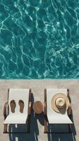 Relaxing by the poolside on a sunny day with a hat and sandals photo