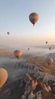 Hot air balloons soaring over the unique rock formations in Cappadocia at sunrise photo