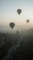 Hot air balloons soaring over the unique rock formations in Cappadocia at sunrise photo