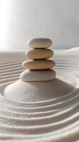 Balanced stone tower on smooth sand with gentle ripples in a tranquil environment photo