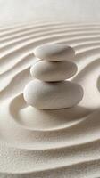 Balanced stone tower on smooth sand with gentle ripples in a tranquil environment photo