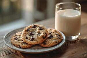 A tempting arrangement of chocolate chip cookies with a glass of milk on a table photo