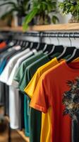A row of colorful t shirts hanging on a rack in a bright clothing store during the day photo