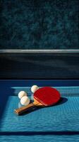 A red table tennis paddle rests on a blue surface alongside three white balls during daylight photo