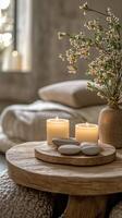 A cozy interior setting featuring candles and flowers on a wooden table in a serene atmosphere photo