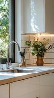 Modern kitchen interior featuring sleek countertops and large windows overlooking nature photo