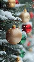 Decorative gold and red ornaments on a snow covered Christmas tree in a winter landscape photo