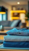 A stack of neatly folded fabrics in a cozy living room with a warm atmosphere photo