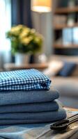 A stack of neatly folded fabrics in a cozy living room with a warm atmosphere photo