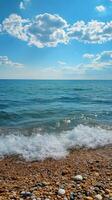 Calm ocean waters reflect the sky on a sunny day with scattered clouds photo