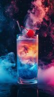 Colorful cocktail with cherry and smoke effect against dark background photo