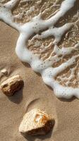 Gentle waves touch sandy shore with smooth stones on a sunny day at the beach photo