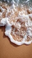 Gentle waves touch sandy shore with smooth stones on a sunny day at the beach photo
