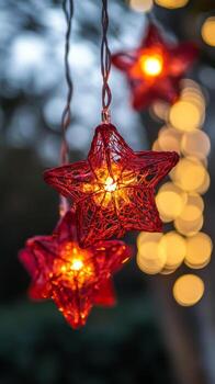 Decorative red star lanterns illuminate a festive outdoor setting during the evening hours photo