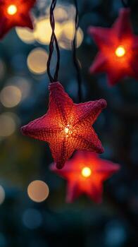 Decorative red star lanterns illuminate a festive outdoor setting during the evening hours photo