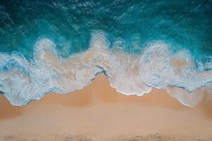 Gentle ocean waves lapping against a sandy beach captured from above during daylight hours photo