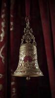 Ornate bell hangs delicately in a warm, vibrant indoor space for the holidays photo