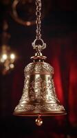 Ornate bell hangs delicately in a warm, vibrant indoor space for the holidays photo