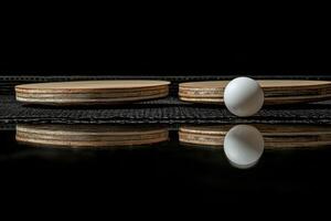 A close view of a table tennis game in progress with balls and net under dramatic lighting photo