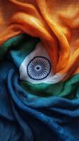 A vibrant close up of silk fabric arranged in a spiral with colors of orange, white, and green photo