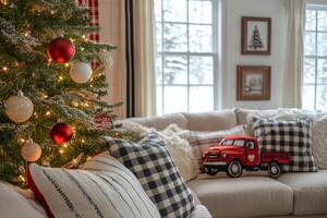 Decorative red truck ornament hanging on a Christmas tree with cozy living room backdrop and pillows photo