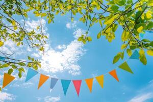 Brightly colored party flags waving under a clear blue sky during a sunny afternoon photo