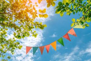 Brightly colored party flags waving under a clear blue sky during a sunny afternoon photo