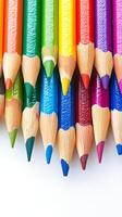 Brightly colored pencils arranged in a circular pattern on a white background for creative projects photo