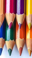 Brightly colored pencils arranged in a circular pattern on a white background for creative projects photo