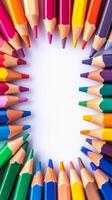 Brightly colored pencils arranged in a circular pattern on a white background for creative projects photo