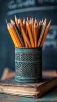 A collection of sharpened yellow pencils arranged in a green can on a wooden desk in a classroom photo