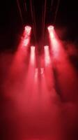Bright red beams of light shining through smoke during an evening event photo