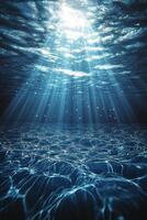 Light rays penetrate clear water creating a serene underwater atmosphere at midday photo