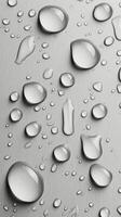 Raindrops on a smooth surface with a soft grayscale background in natural light photo
