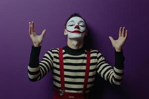 A performer dressed as a clown presents an entertaining act against a vibrant purple backdrop photo