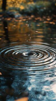 Ripples expanding in dark water under rain creating a calm and tranquil atmosphere photo