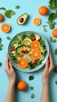 Fresh salad with oranges, avocado, and spinach on a light blue background for healthy eating photo