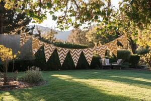 Colorful decorative flags hanging from a tree in a sunny garden during late afternoon photo