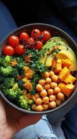 Healthy vegetable bowl with chickpeas and roasted squash served in a rustic bowl photo