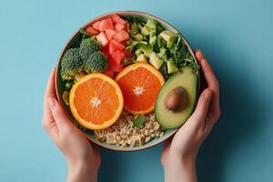 A vibrant bowl filled with fresh vegetables and fruits shows hands holding it photo