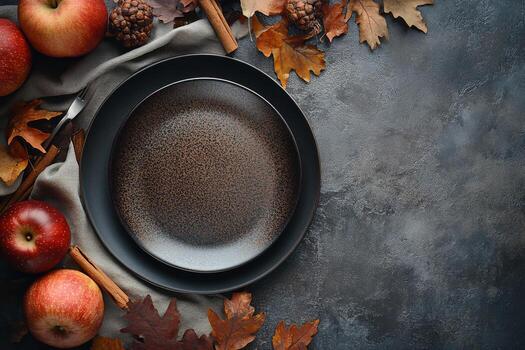 An elegant black plate surrounded by autumn leaves and fresh apples on a rustic table setting photo